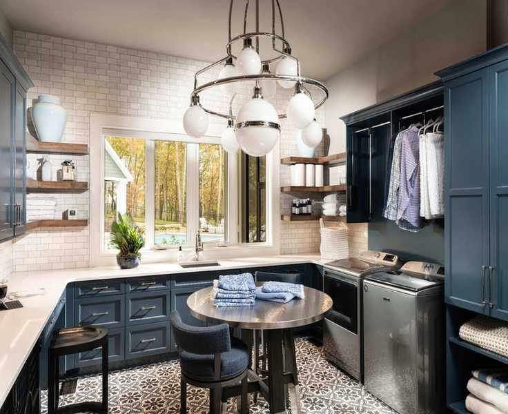 Spacious laundry room with custom blue cabinets