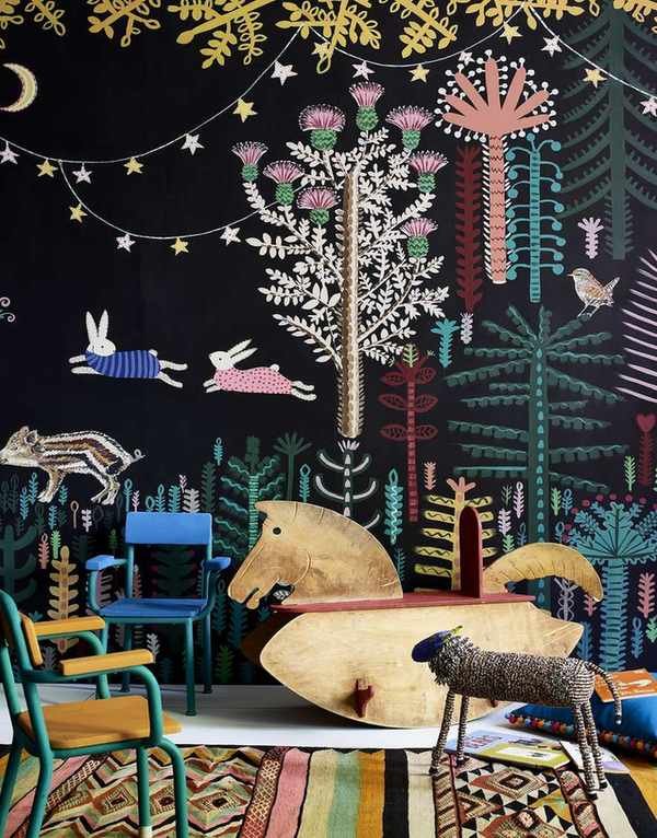 Playroom ideas with a coordinated and colorful blackboard paint, furniture including wooden rocking horse and patterned rug.