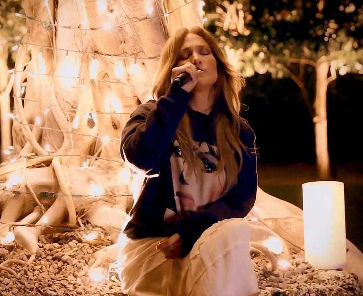 jennifer lopez against a tree background