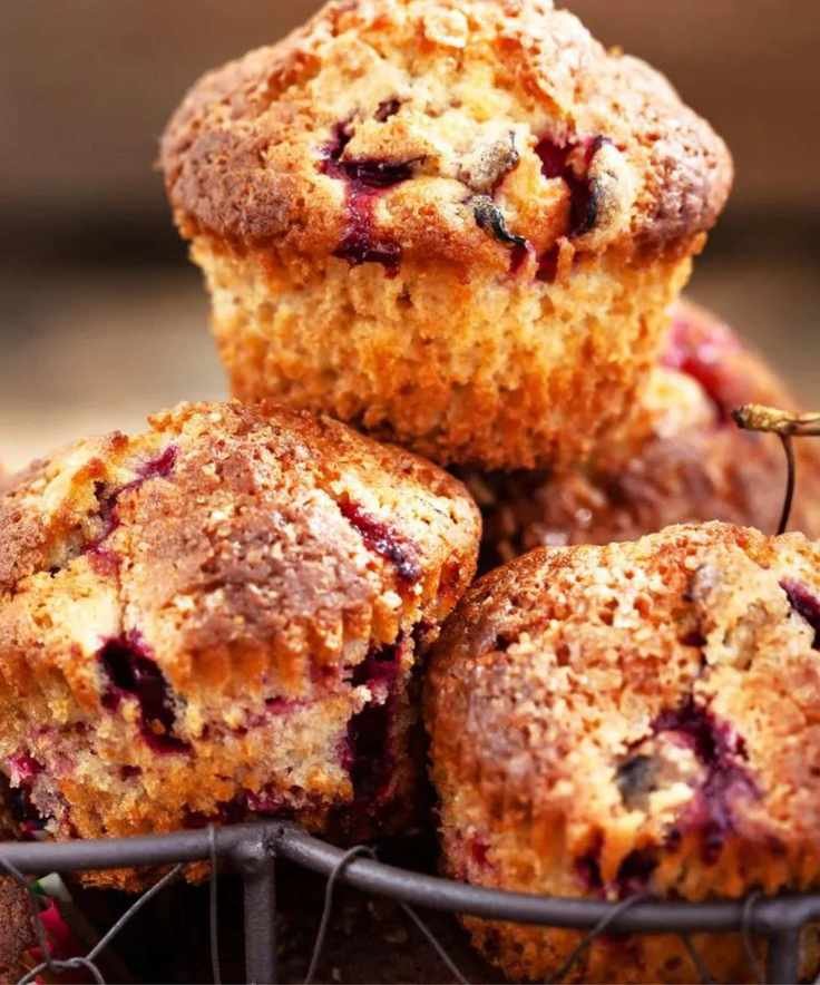 Cherry muffins in a basket with fresh cherries