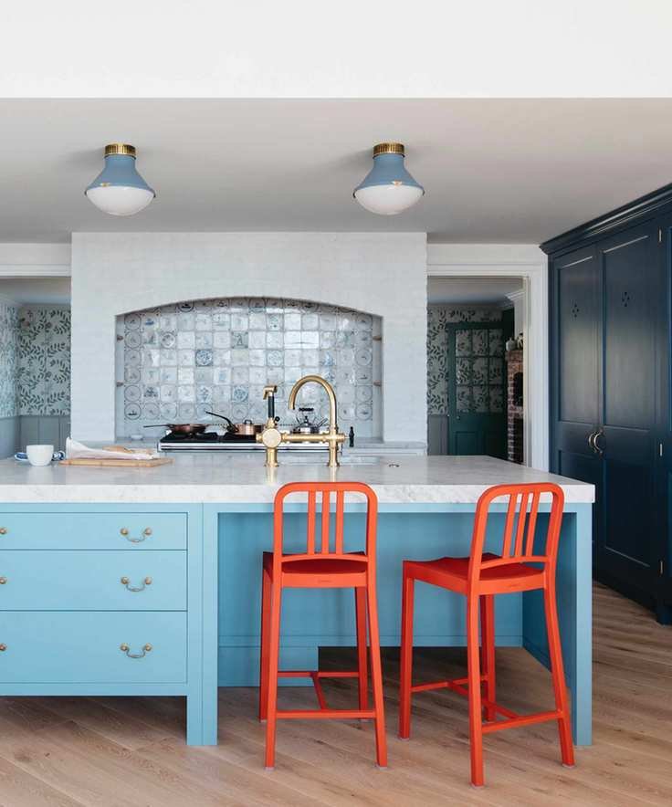 Blue kitchen with sky blue island and dark cabinetry