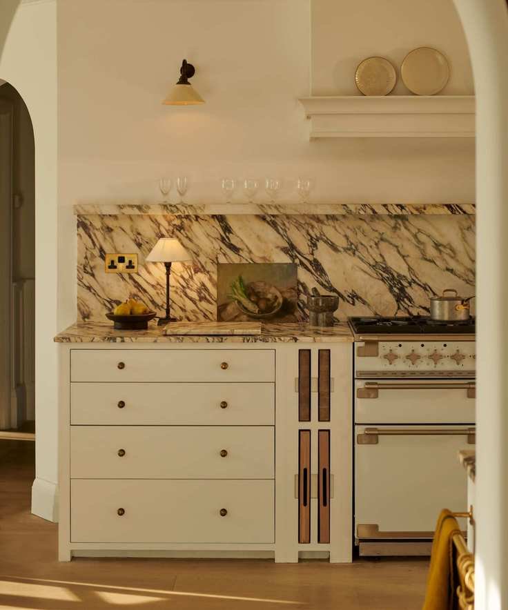neptune neutral kitchen with shaker style cabinets and marble countertop and backsplash