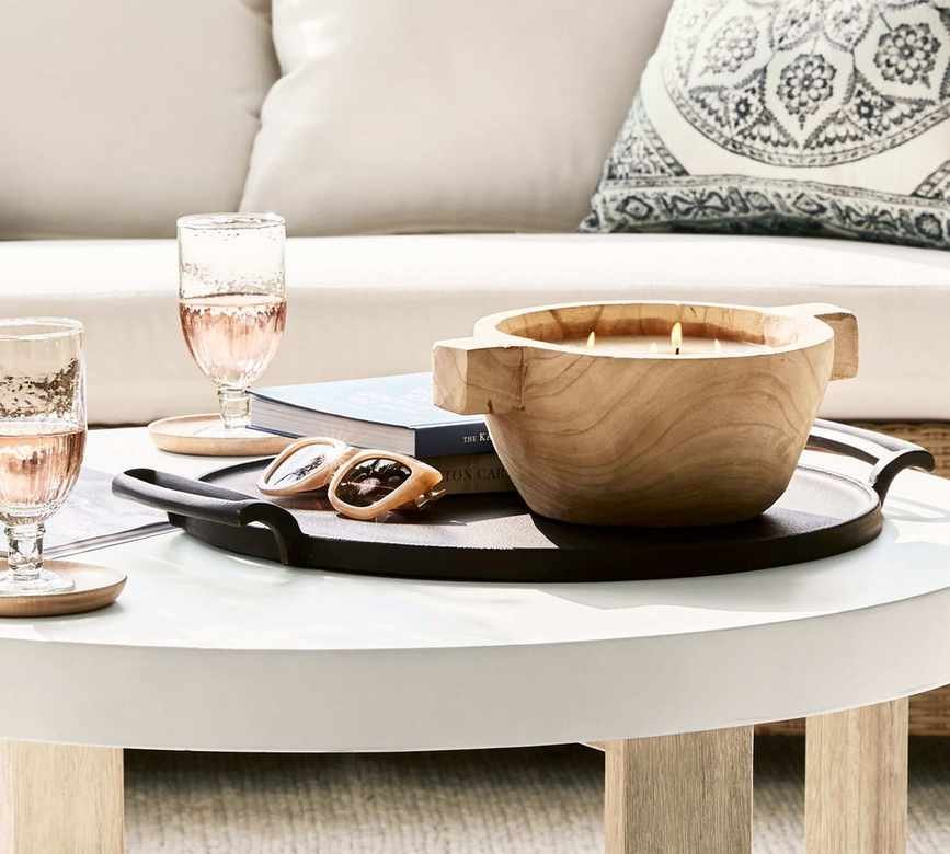 A wooden four-wick candle on a coffee table