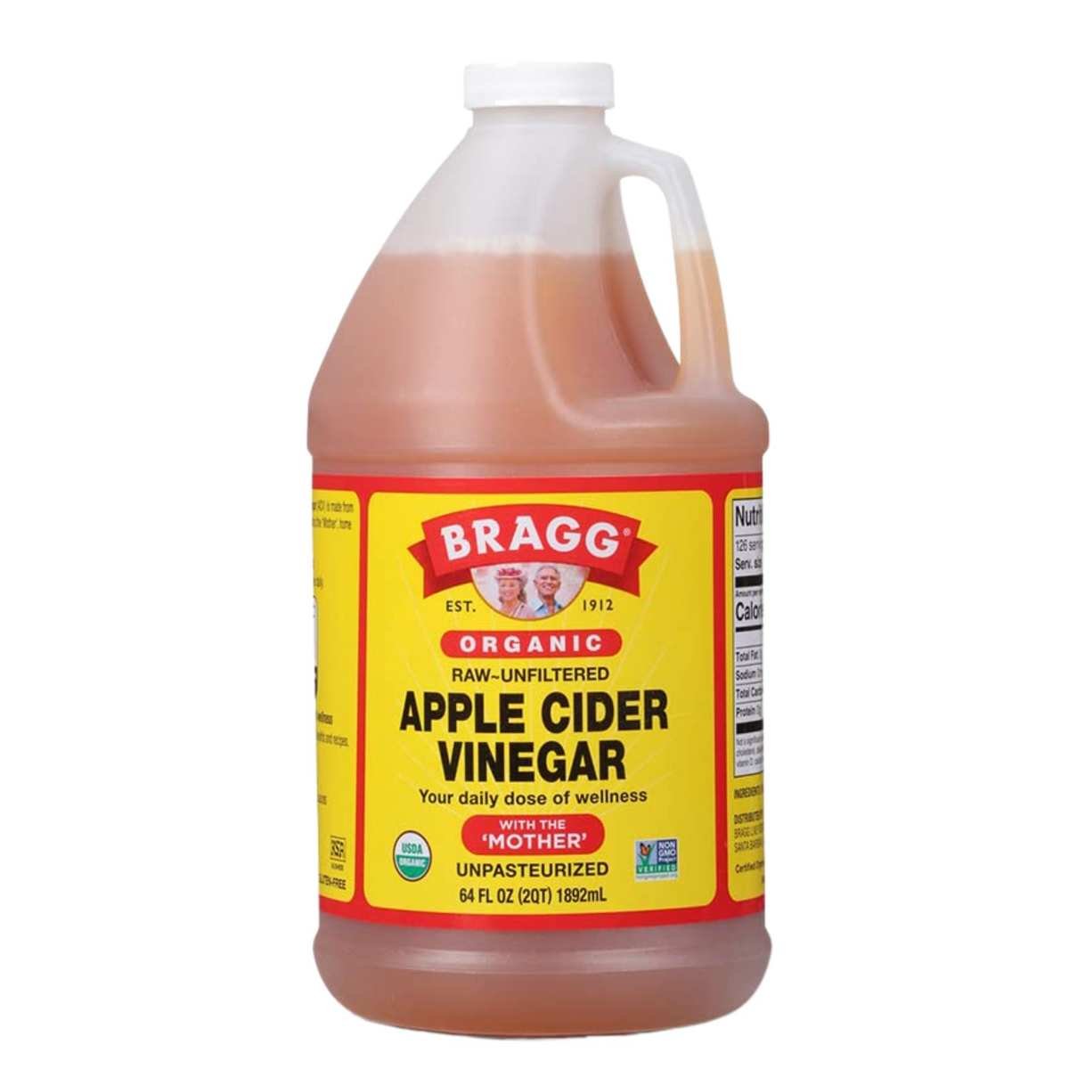 A large plastic bottle of apple cider vinegar with a white lid and yellow, red and black label