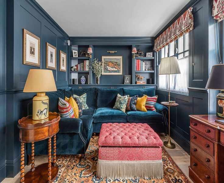 Barlow & Barlow blue living room with artwork, blue sofa and pink footstool