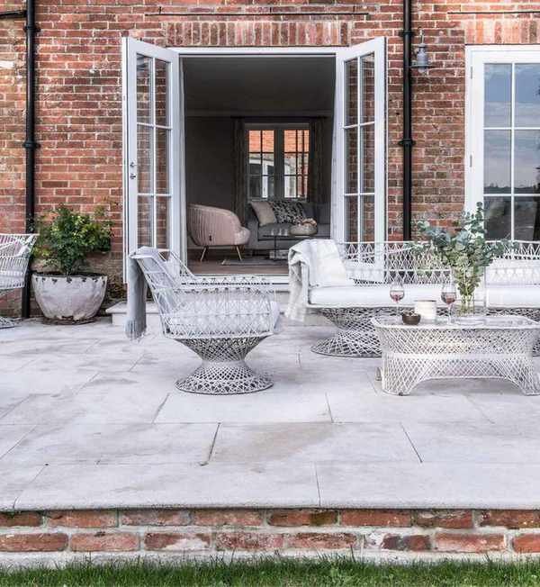 A raised paved patio outside a modern house