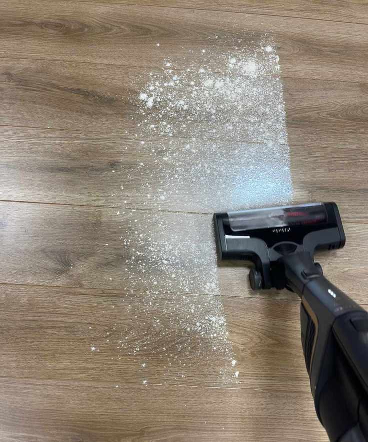 Miele Triflex HX2 Pro vacuuming flour and sugar on wooden floor