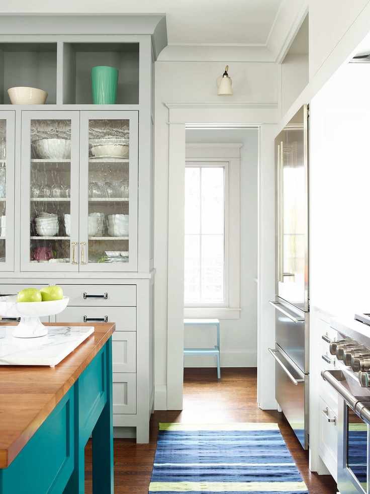 Kitchen cabinets painted with Benjamin Moore gloss paint in vibrant colors.