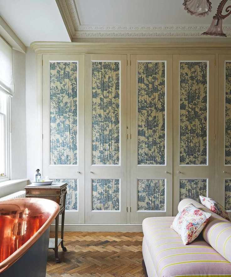 neutral green bedroom with patterned wardrobe panels