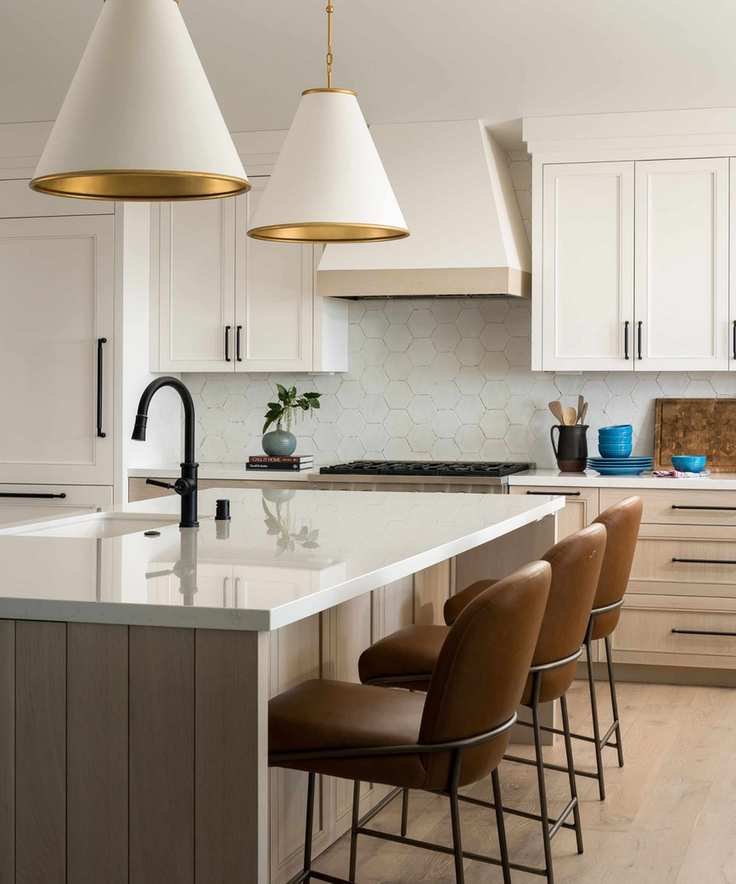 a neutral kitchen with white upper cabinets and wooden island