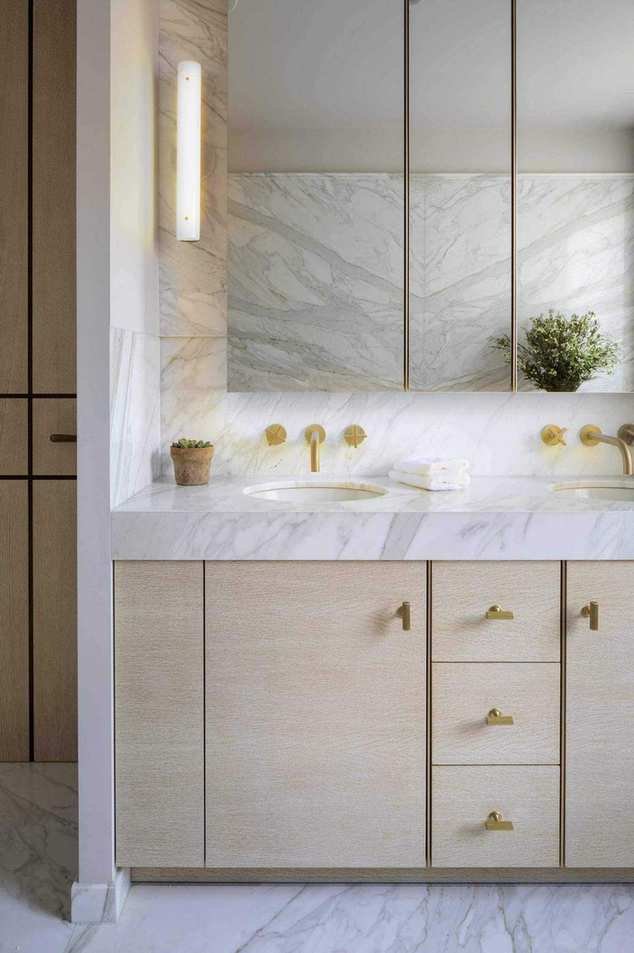 A bathroom vanity with storage and mirrors above