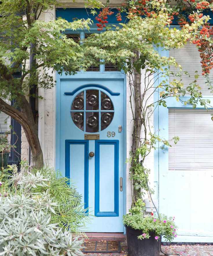 decorative front door with trees and plants surrounding it, London Mews