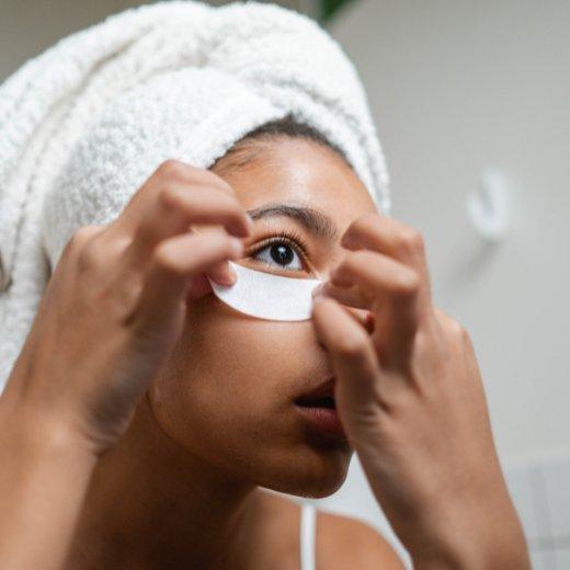 Image of model applying an eye mask to their face