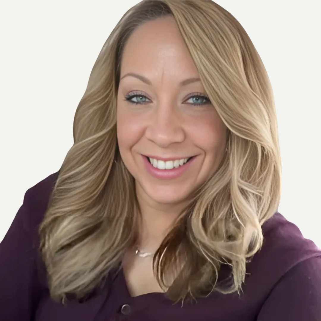 a headshot photo of professional organizer, Tina Priestly: a woman in a dark purple button up long sleeve with medium blonde hair smiling at the camera