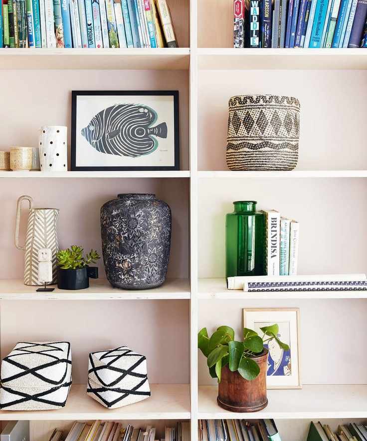 pink shelving with decorative objects and books