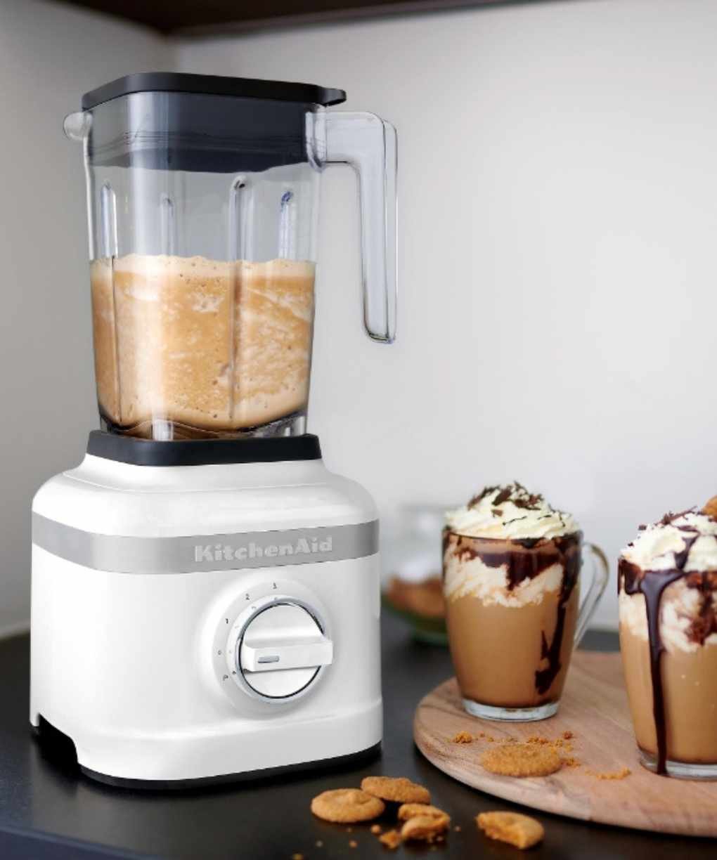 Two chocolate biscoff milkshakes next to a KitchenAid blender