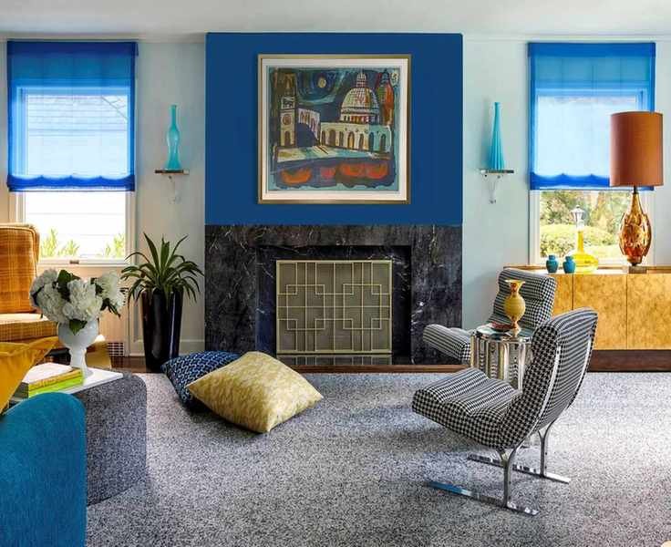 Mid-century modern living room with blue curtains and blue feature wall