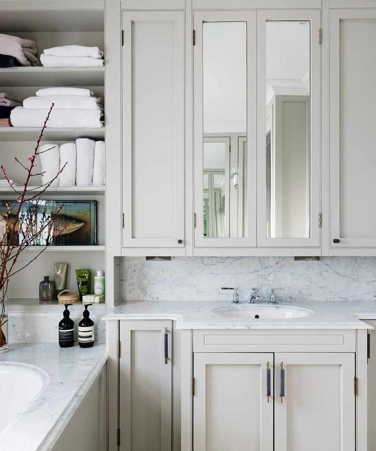 bathroom with bath and sink with vanity and towels on shelves