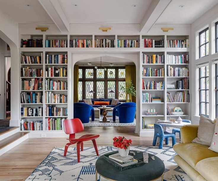 Living area featuring a floor-to-ceiling bookshelves divider.