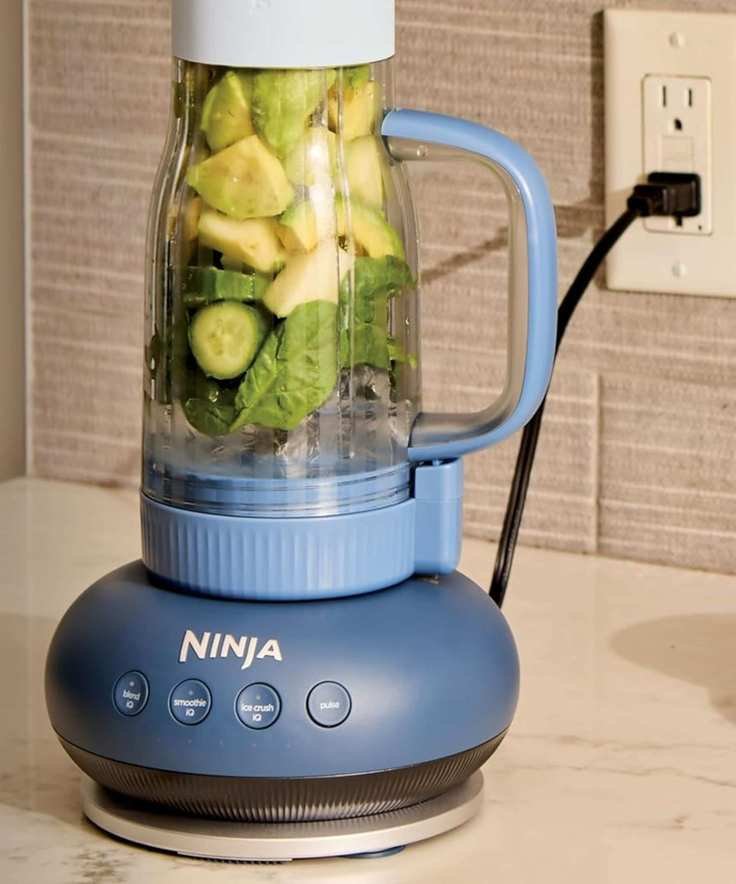 A blue Ninja BlendBoss tumbler blender on a kitchen counter.