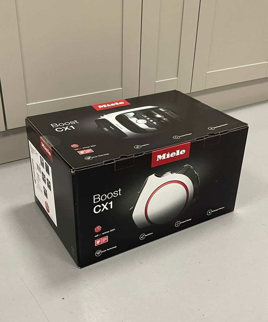 Miele Boost CX1 canister vacuum original packaging on concrete floor
