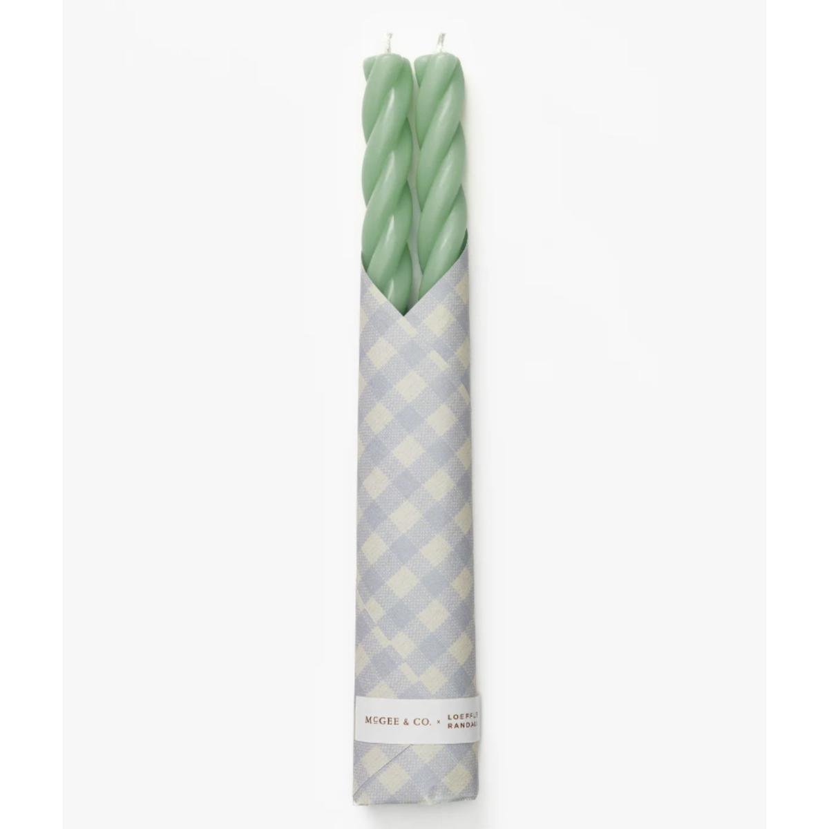 Green twist taper candles wrapped in gingham paper