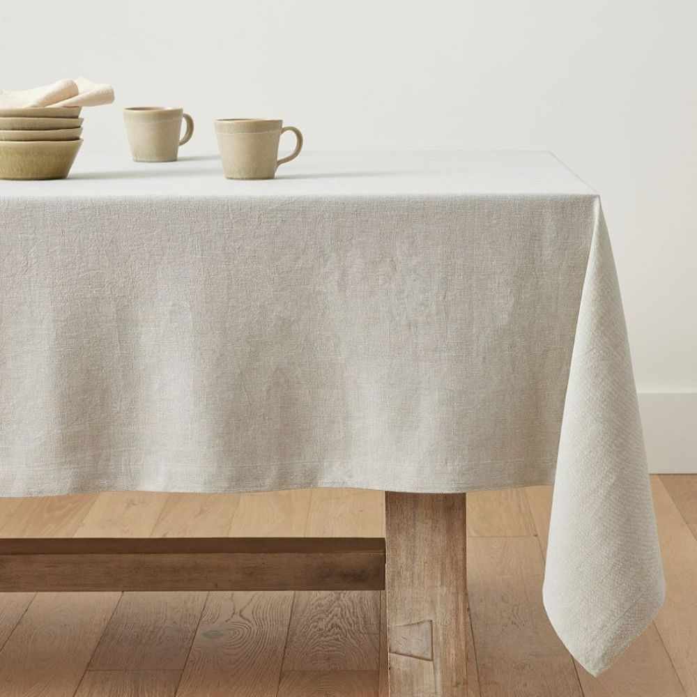 Cream linen tablecloth on a wooden table