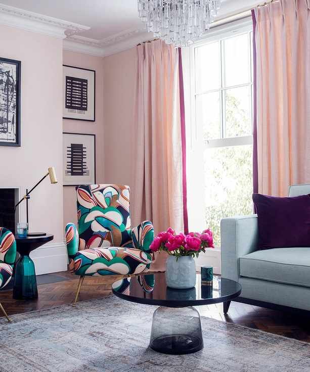 Pink living room with matching curtains and abstract print armchairs
