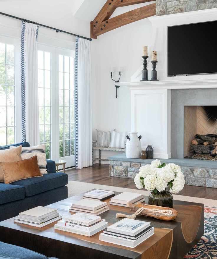 white living room with navy sofa and custom drapery