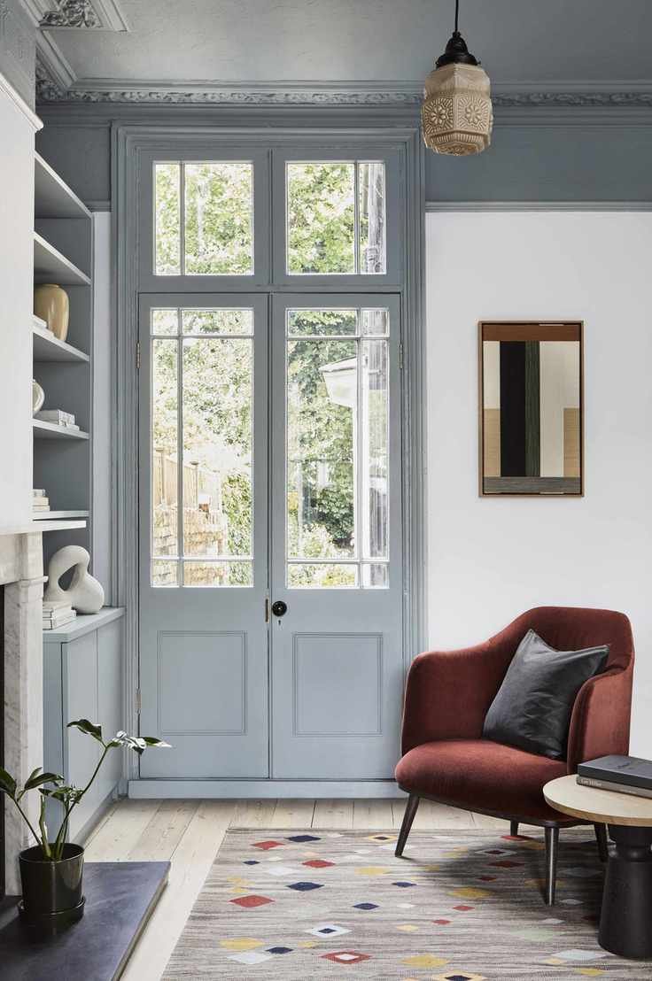 Grey door and ceiling, red velvet armchair