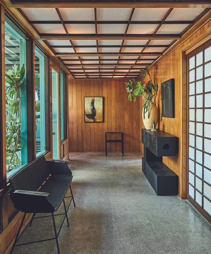 Wooden walls and sliding doors, green framed windows