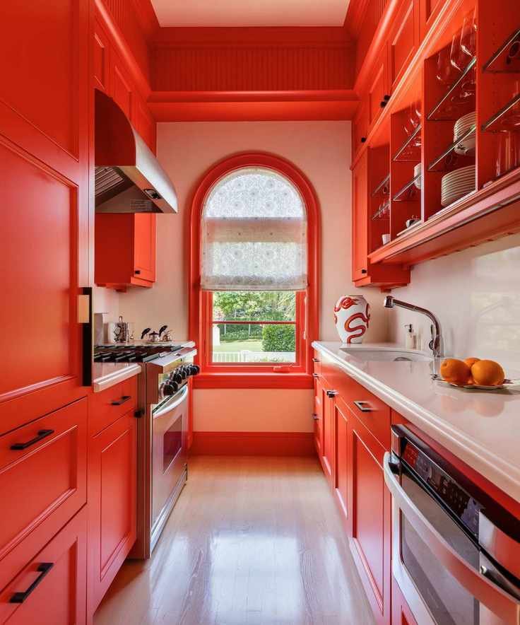 bright red modern kitchen with arched window