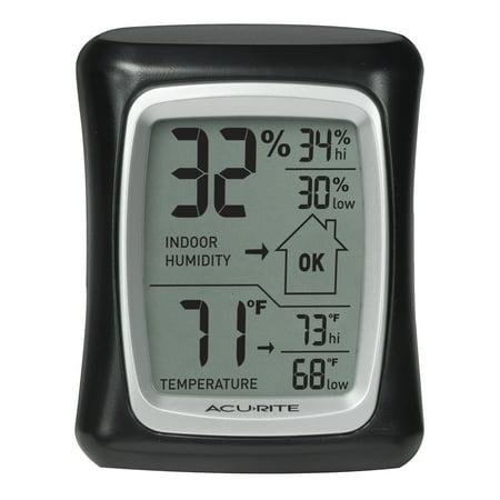 A small rectangular hydrometer and thermometer for home. Black framed, digital display