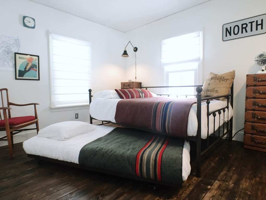 cabin bedroom with trundle beds and camp blankets