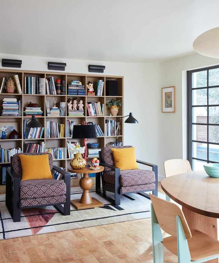 Bright room with large bookshelves and cozy seating.
