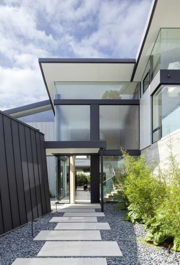 Asymmetrical front yard landscaping ideas using pavers and patterned stones