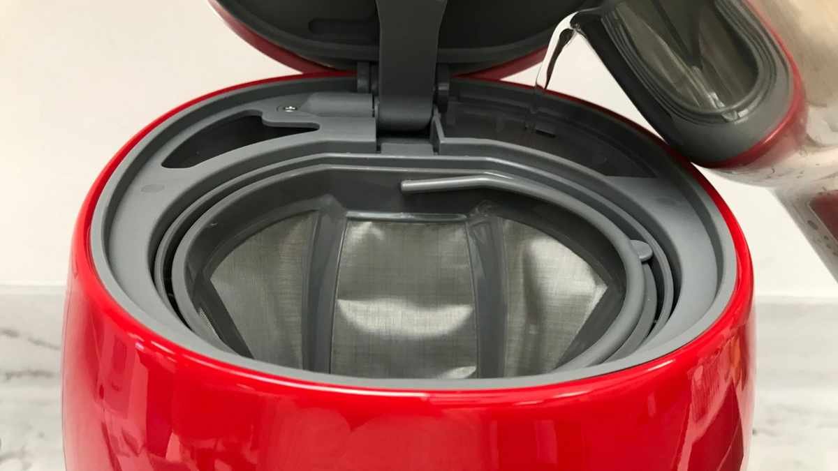 Pouring water into the back reservoir of the smeg coffee maker