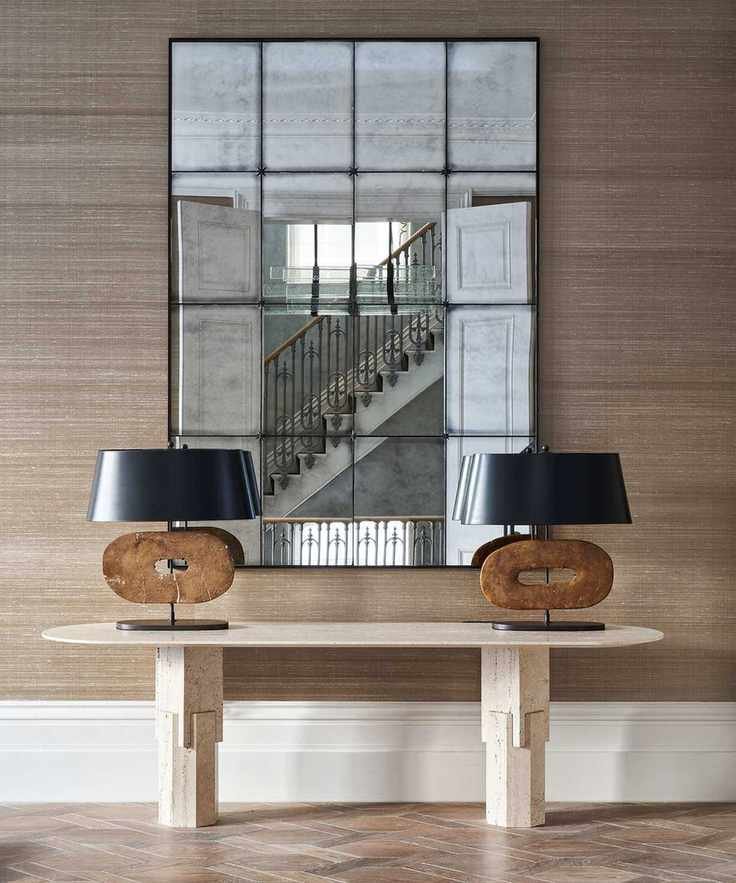 Hallway with neutral textured wallpaper and console table