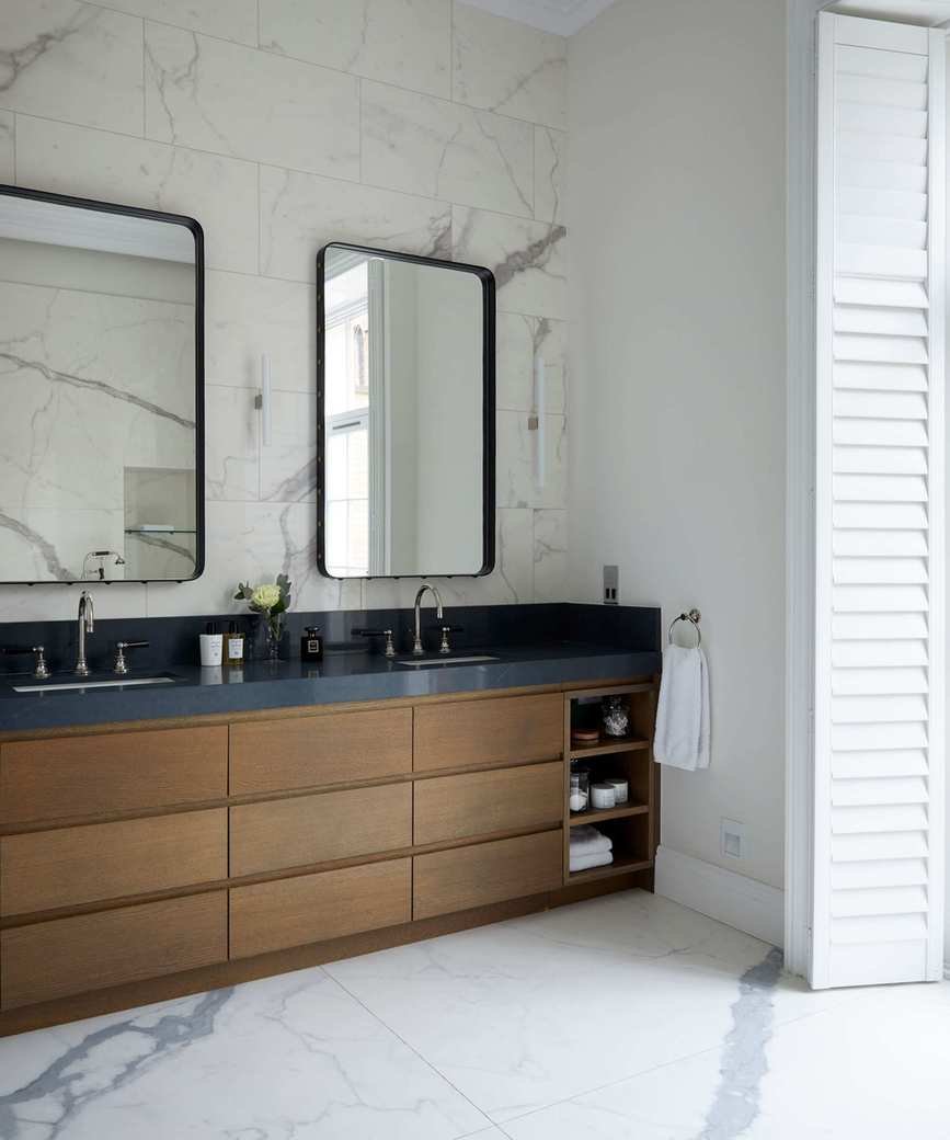 An example of bathroom storage ideas showing a bathroom with a wooden vanity unit in a Georgian townhouse in London