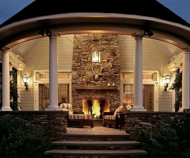 Porch with columns, built-in fireplace, striped loungers and steps