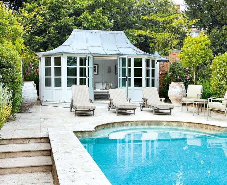 Compact pool house design with classic style beside a rounded swimming pool.