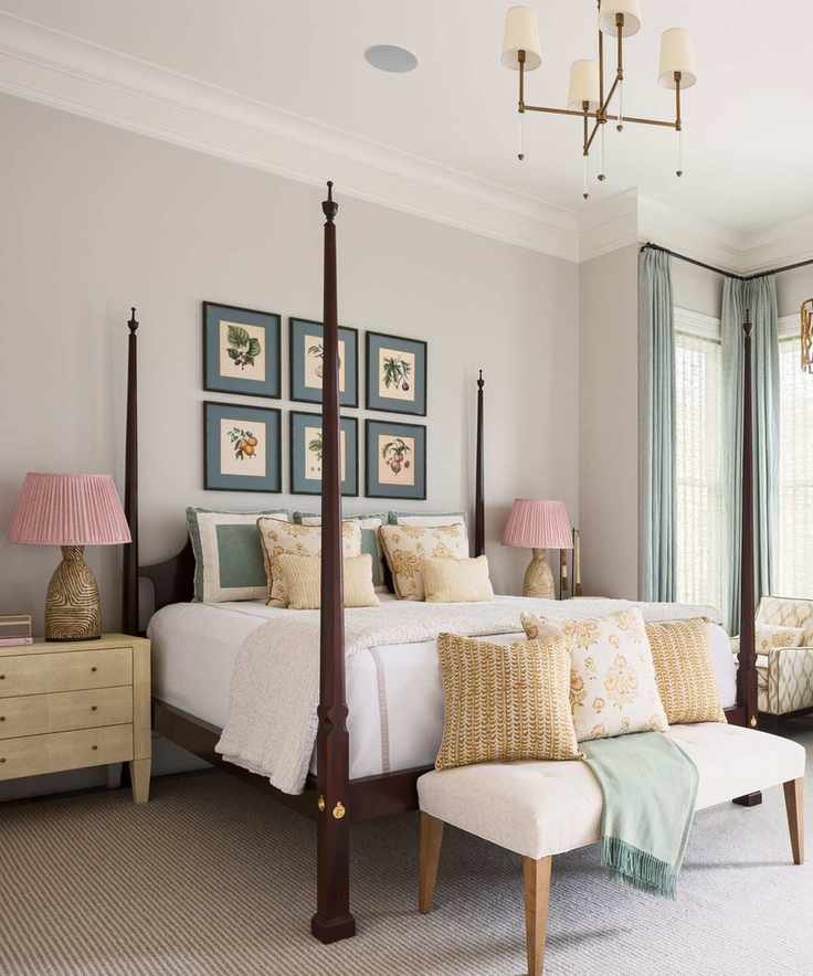 Cream bedroom with four poster and art above bed