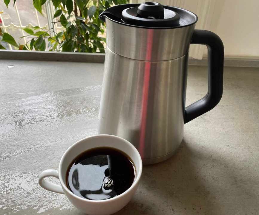 OXO 8-cup coffee maker with a cup of coffee