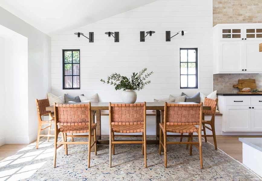 modern farmhouse style kitchen with ribbed wooden pantry unit and black metal pendant lights