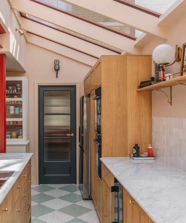 Pink kitchen with wood cabinets