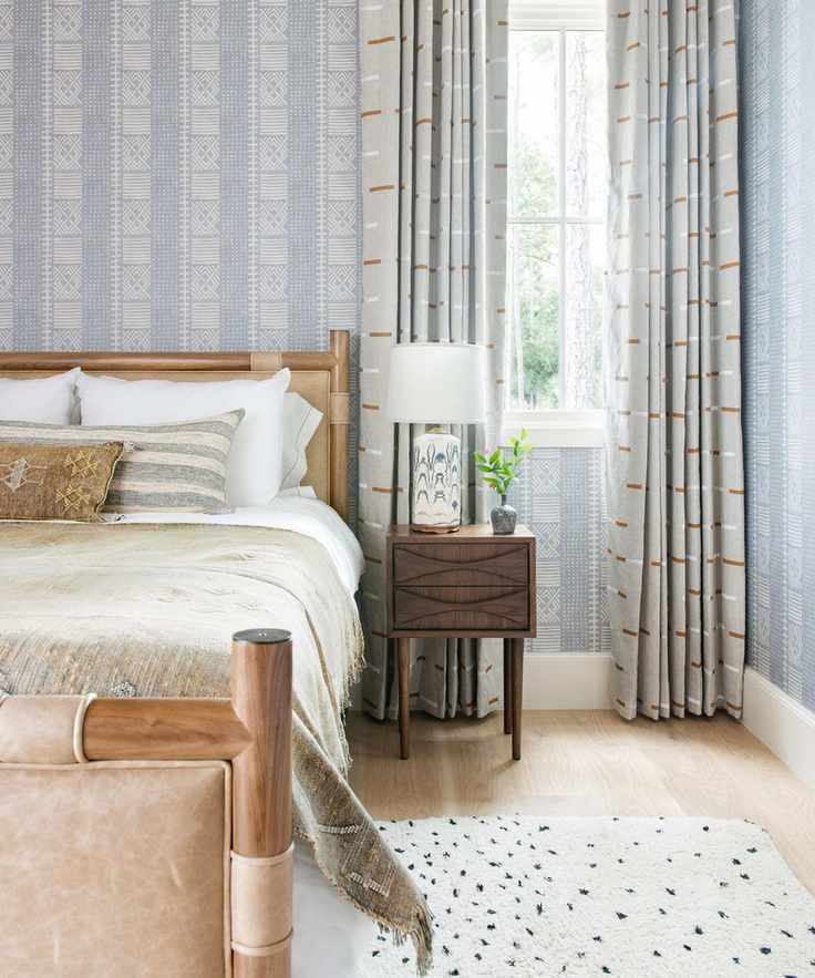 Pale gray/blue bedroom looking to bed and window