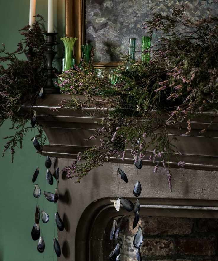 Close up of mantel decorated with foliage and shells