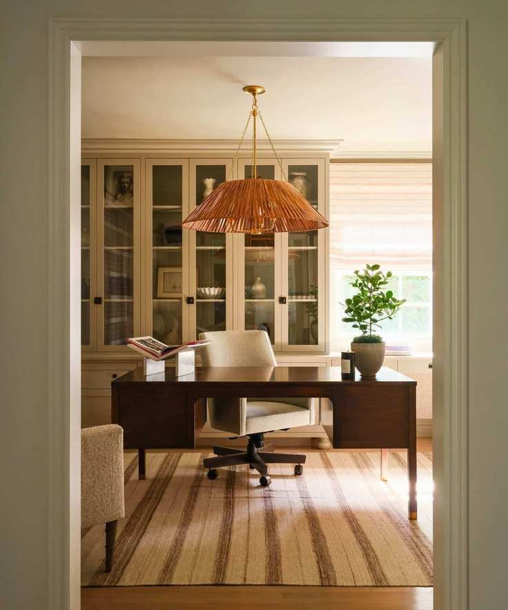 home office with striped rug and dark desk