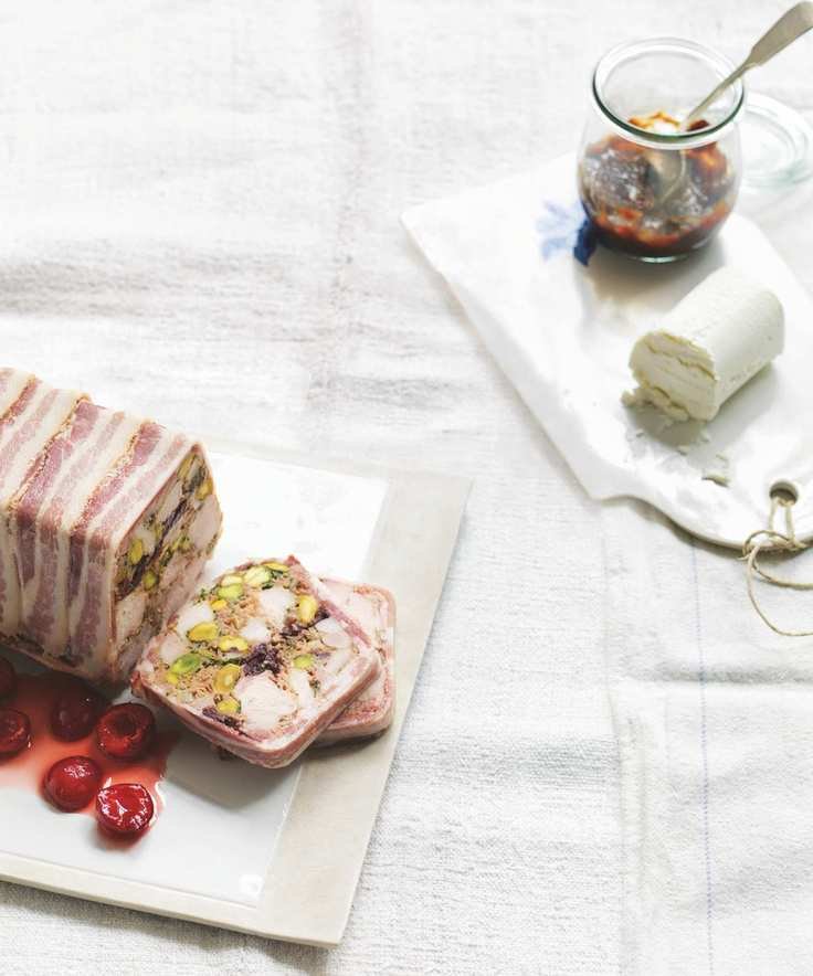 chicken and pistachio terrine with pickled cherries on a white board