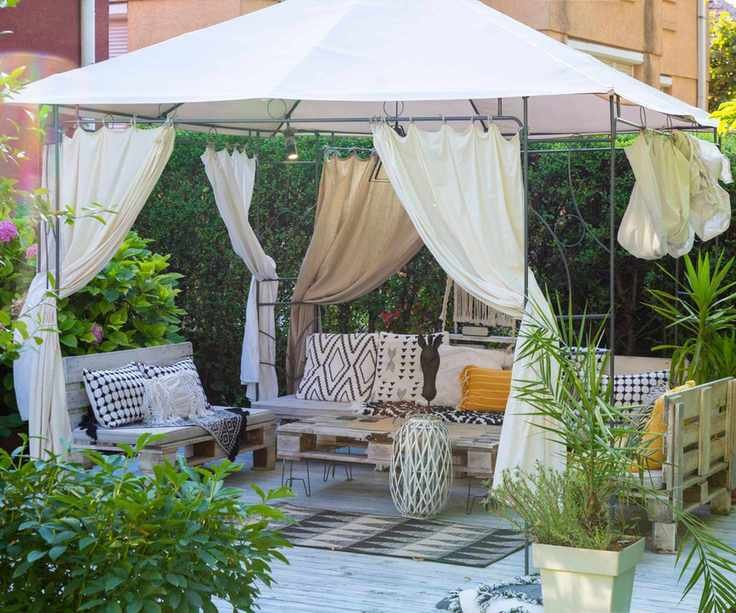 A modern gazebo with wooden sofas